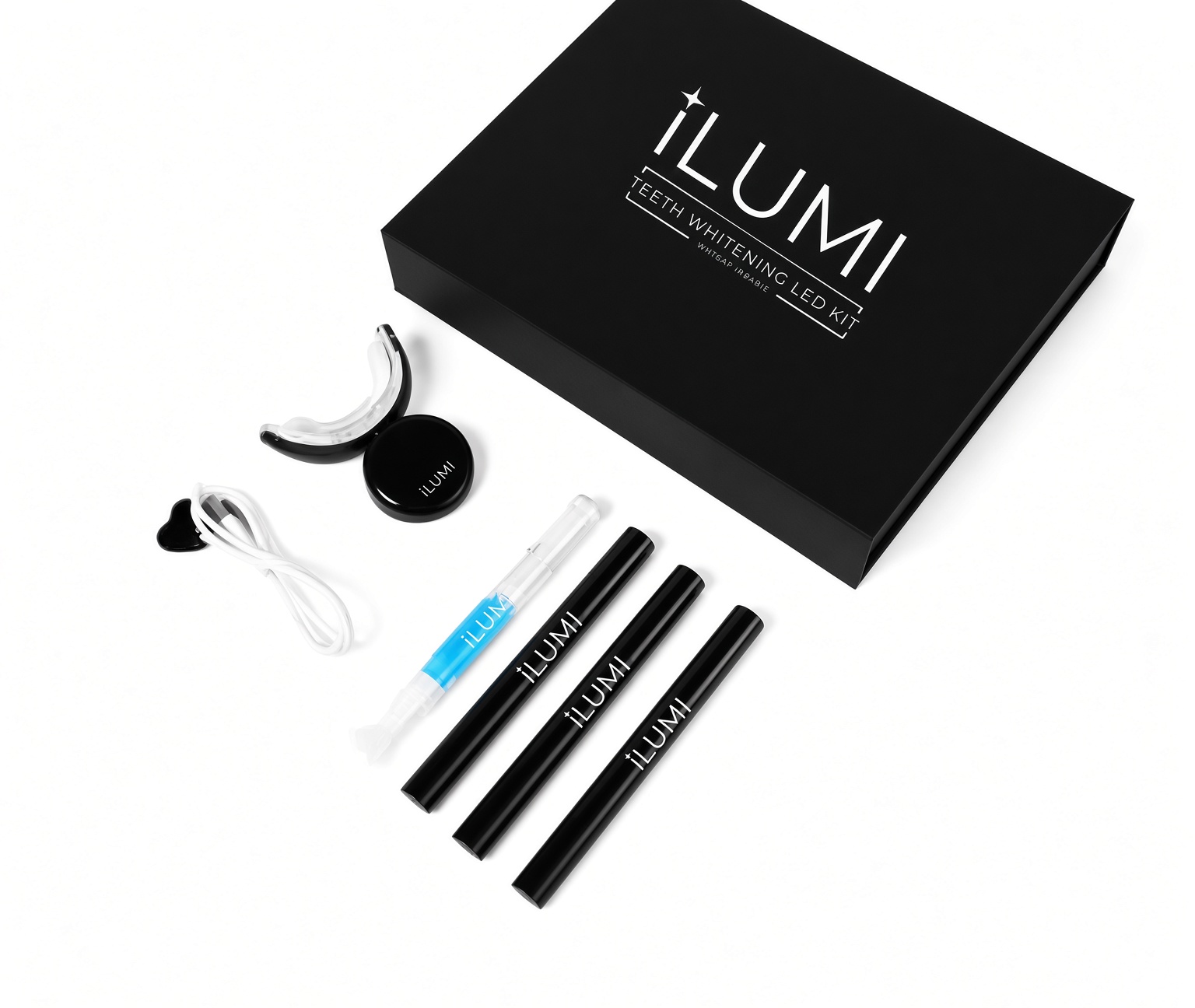 ILUMI LED Teeth Whitening Kit unboxed flat lay — magnetic box, LED mouthpiece, charging cable, three whitening gel pens and a blue desensitizing gel pen, formulated by Harvard-trained endodontist Dr. Dave Steuer