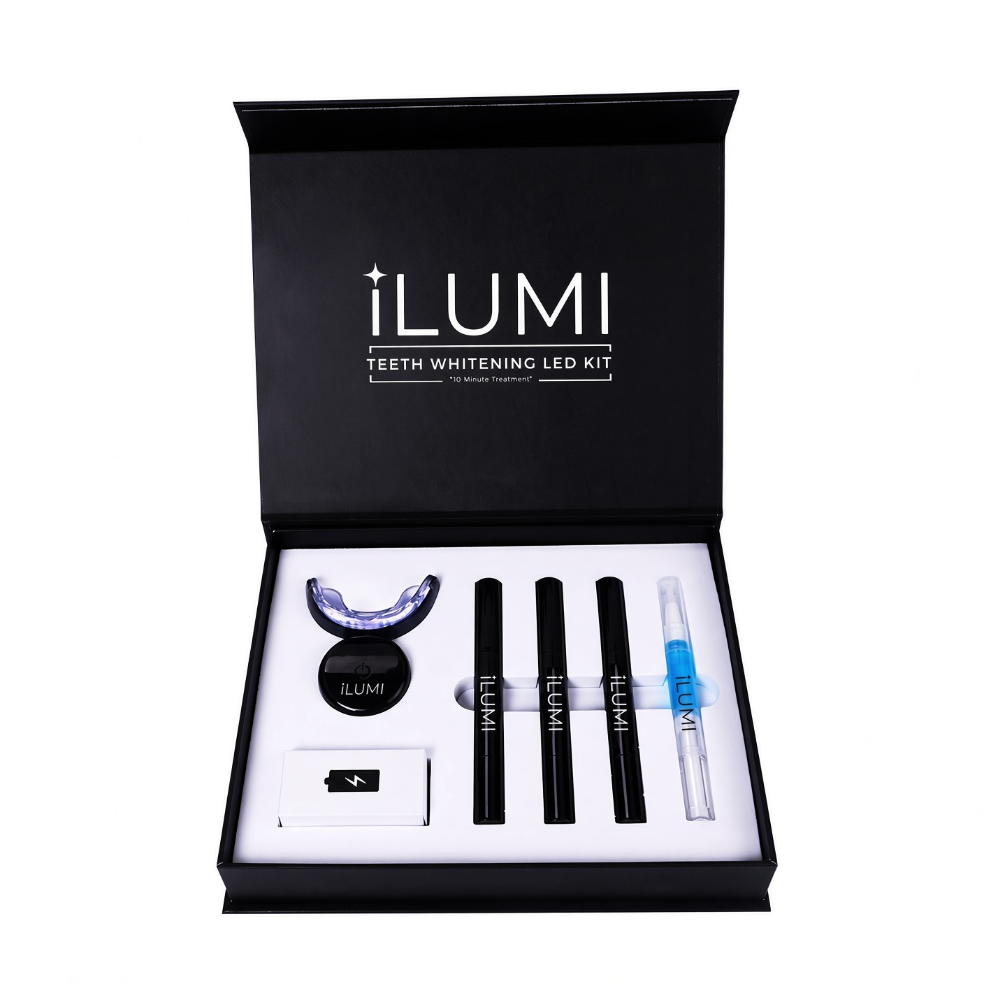 ILUMI LED Teeth Whitening Kit — open presentation box with the cordless LED device, three whitening gel pens and a blue desensitizing gel pen